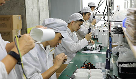 an assembly line full of Chinese workers