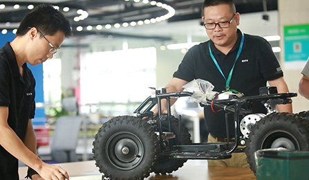Chinese men looking at a prototype