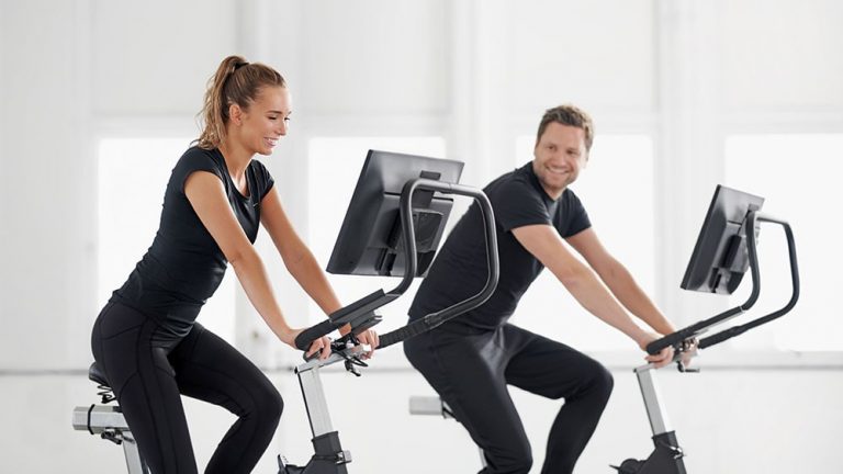 Twp people riding a fitness bike